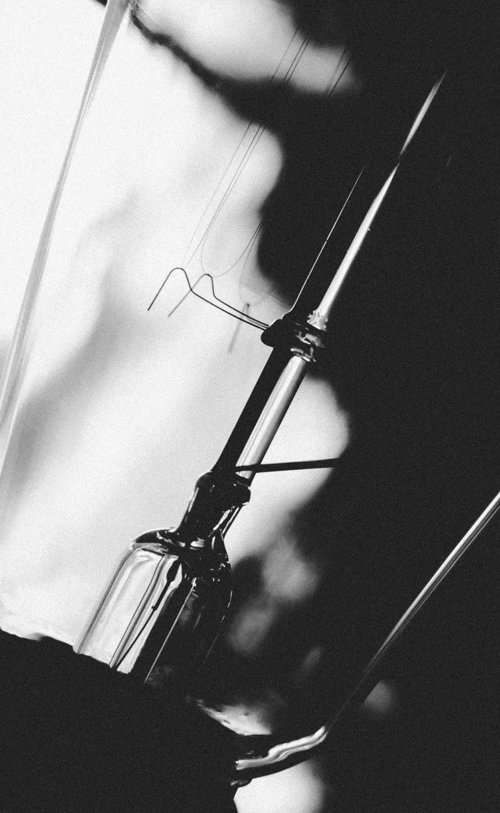 Intravenous drip bottle and needle in high contrast